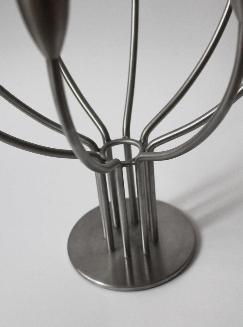 Close-up of the Brushed Metal Swedish Candelholder by Vintage Stories, featuring a round base and Scandinavian-inspired design, photographed against a plain white background.