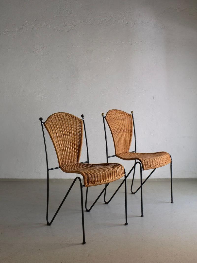 Two Frederick Weinberg wicker iron chairs with curved black frames