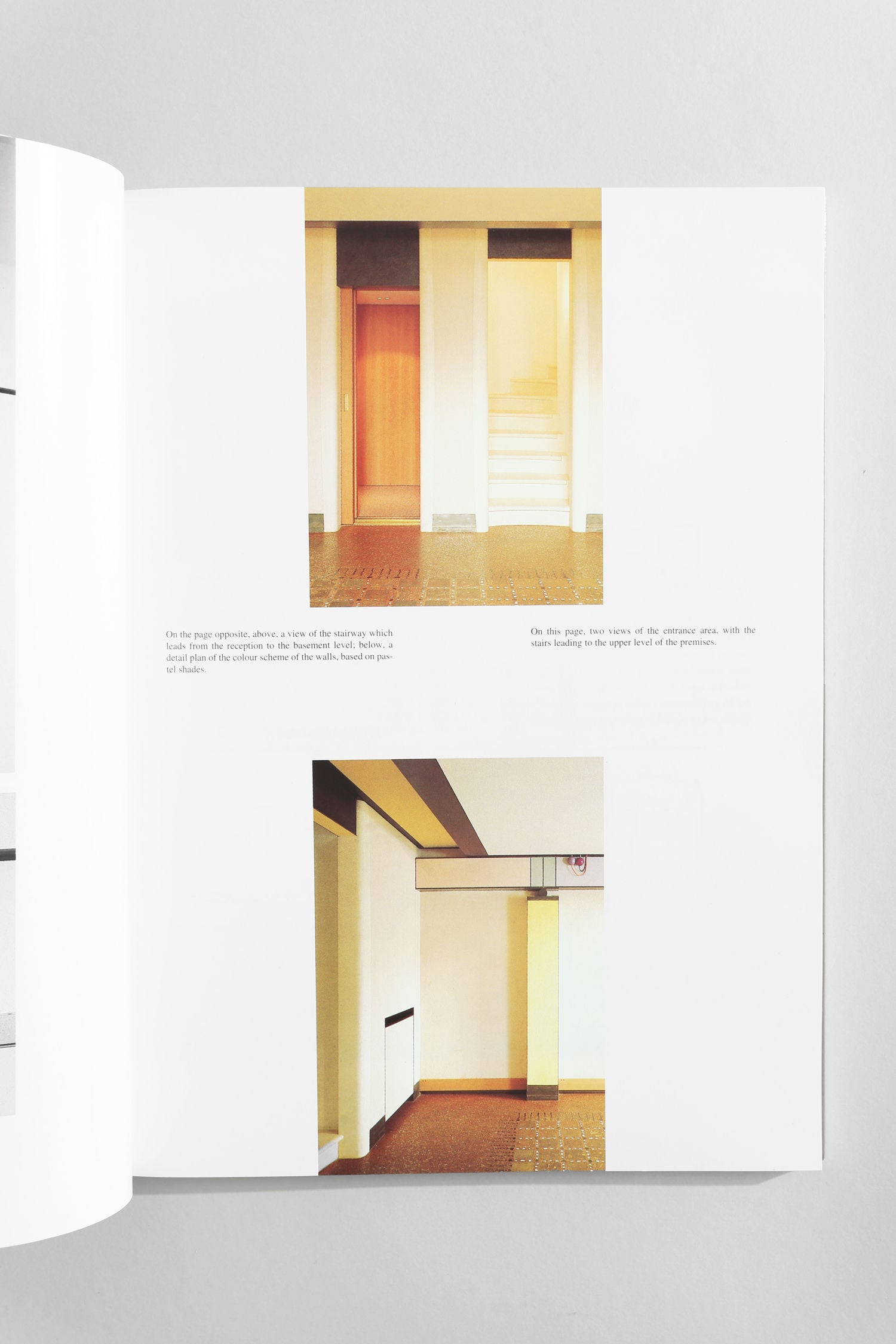 A page from Villa’s 'Commercial Space: Offices, Design and Layout' book features two modern interior photos—one with a wooden door and staircase, another of a hallway with white walls, heater, and tiled floor. Captions highlight architectural details.