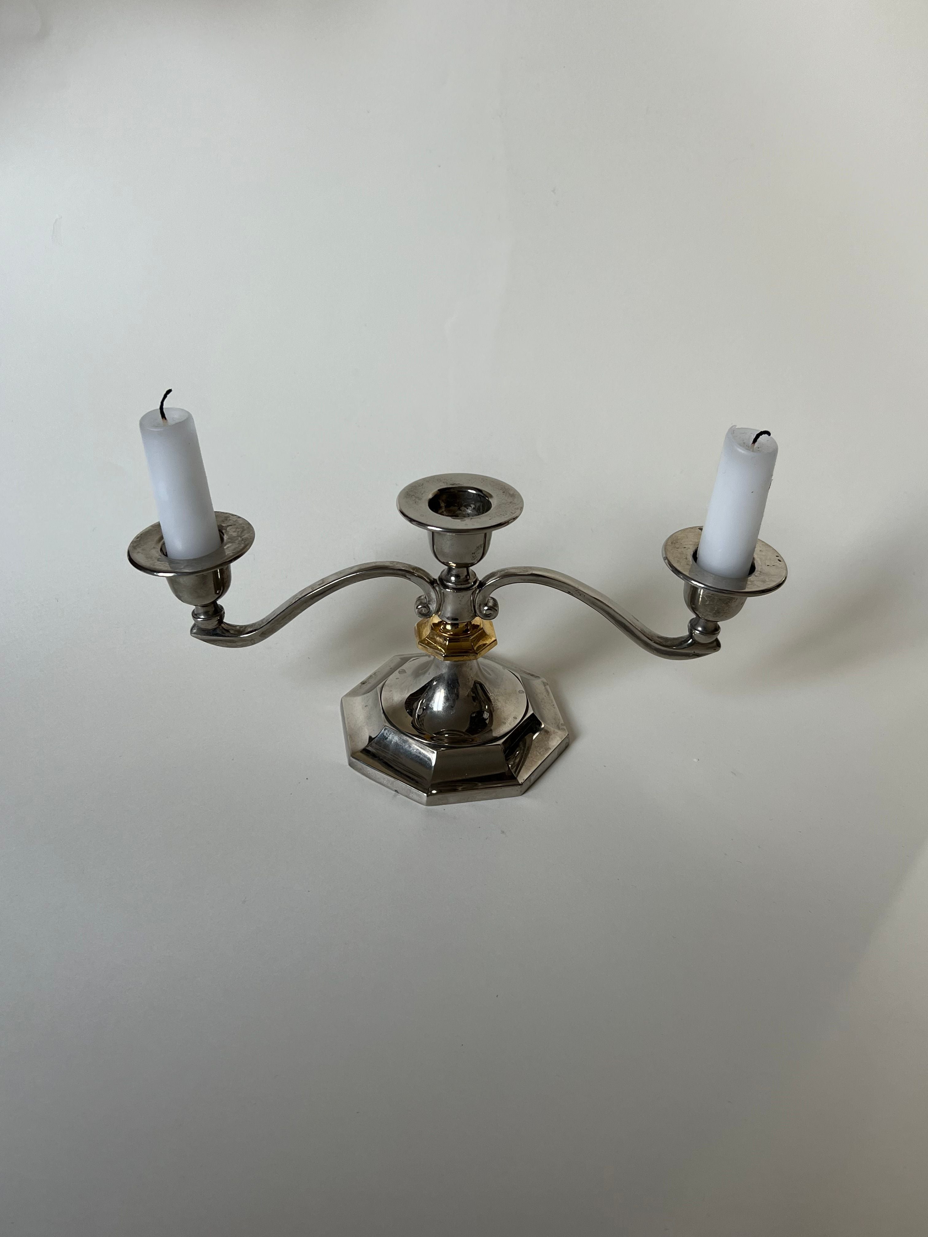 Three-piece candleholder featuring a modern design with a mix of silver and gold tones