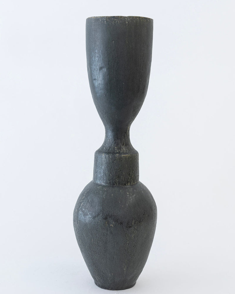 The 'Isolated n.36' Vase by Canoa Lab features a dark, matte ceramic finish with a rounded base and narrow neck, highlighting Mediterranean design on a plain white background.