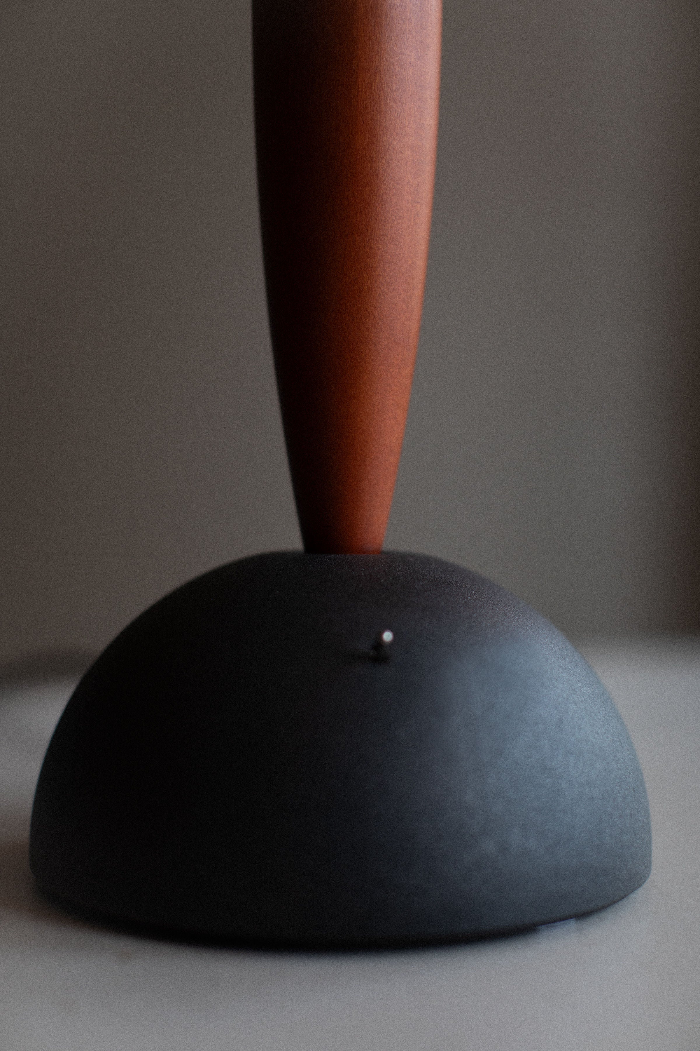 A close-up of a Vintage Murano Lamp with a matte black base and a slender, tilted neck crafted by Murano glassmakers against a softly blurred background from Out For Lunch.