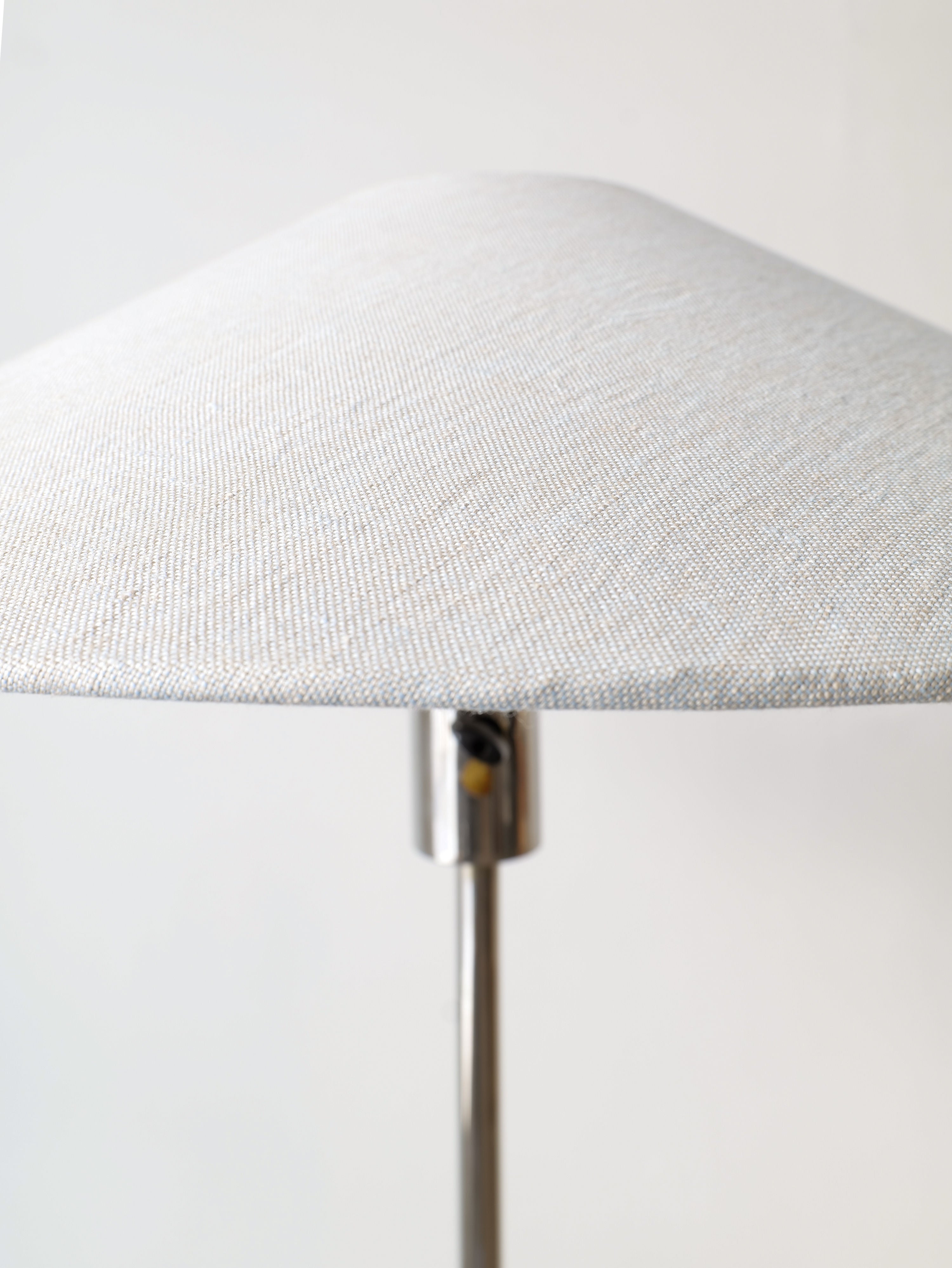 A close-up view of a Deco Floor Lamp Harald Notini 1940s by Collection apart, featuring a metallic stand and a large, conical, light grey fabric shade. The background is a plain, light-colored wall that subtly highlights the Swedish Modern design elements from Arvid Böhlmarks Lamp Factory.