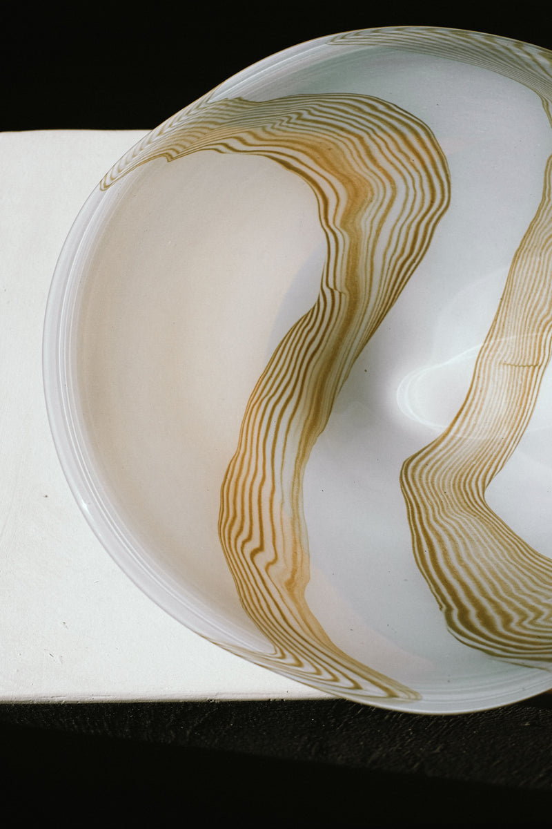 Large blown glass bowl with flowing amber striped pattern detail