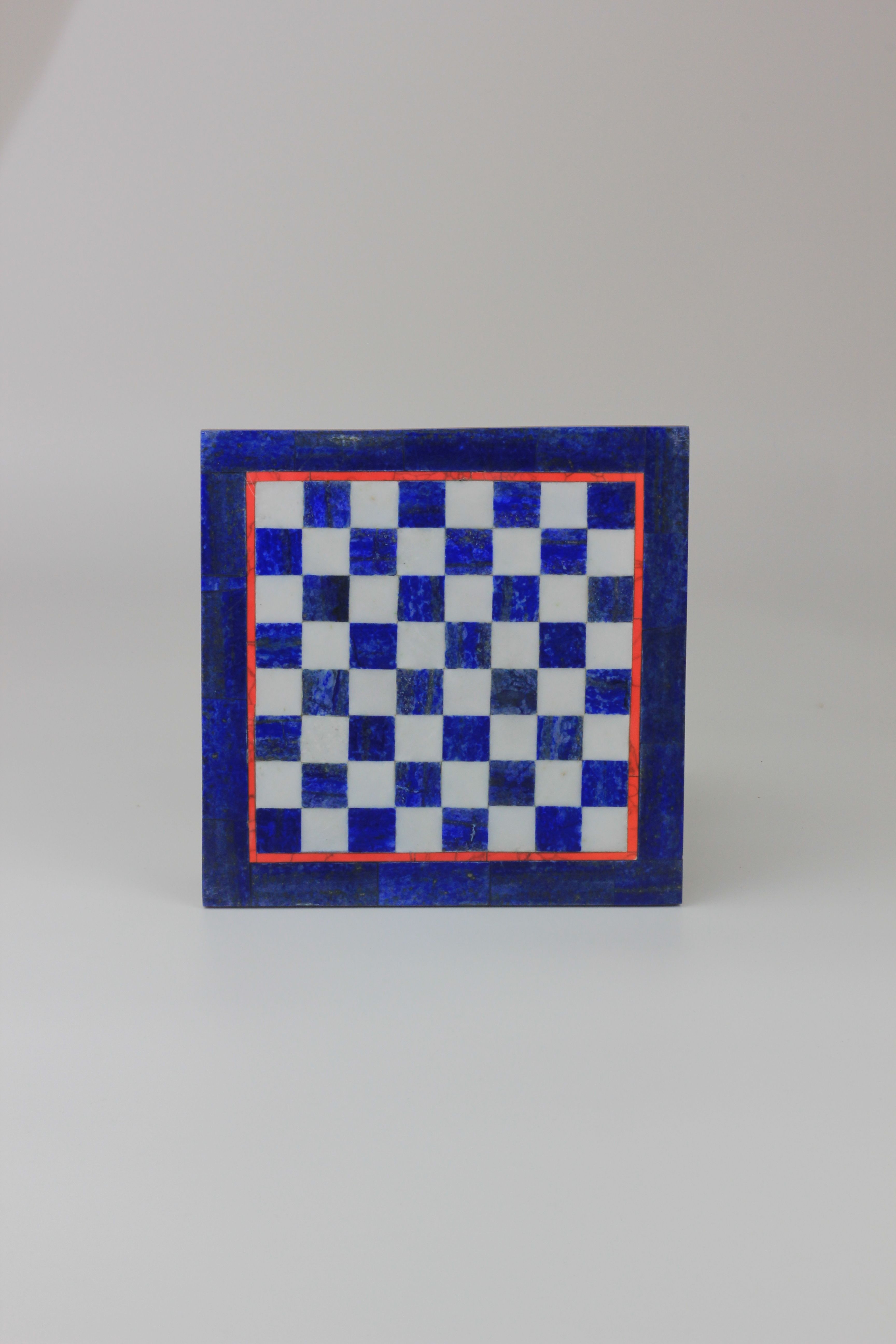 A compact, rectangular Lapis Lazuli Chessboard from Boga Avante Shop features an exquisite blue and white checkered design, bordered by a blue edging with a delicate red line just inside it, all set against a simple, light gray backdrop.