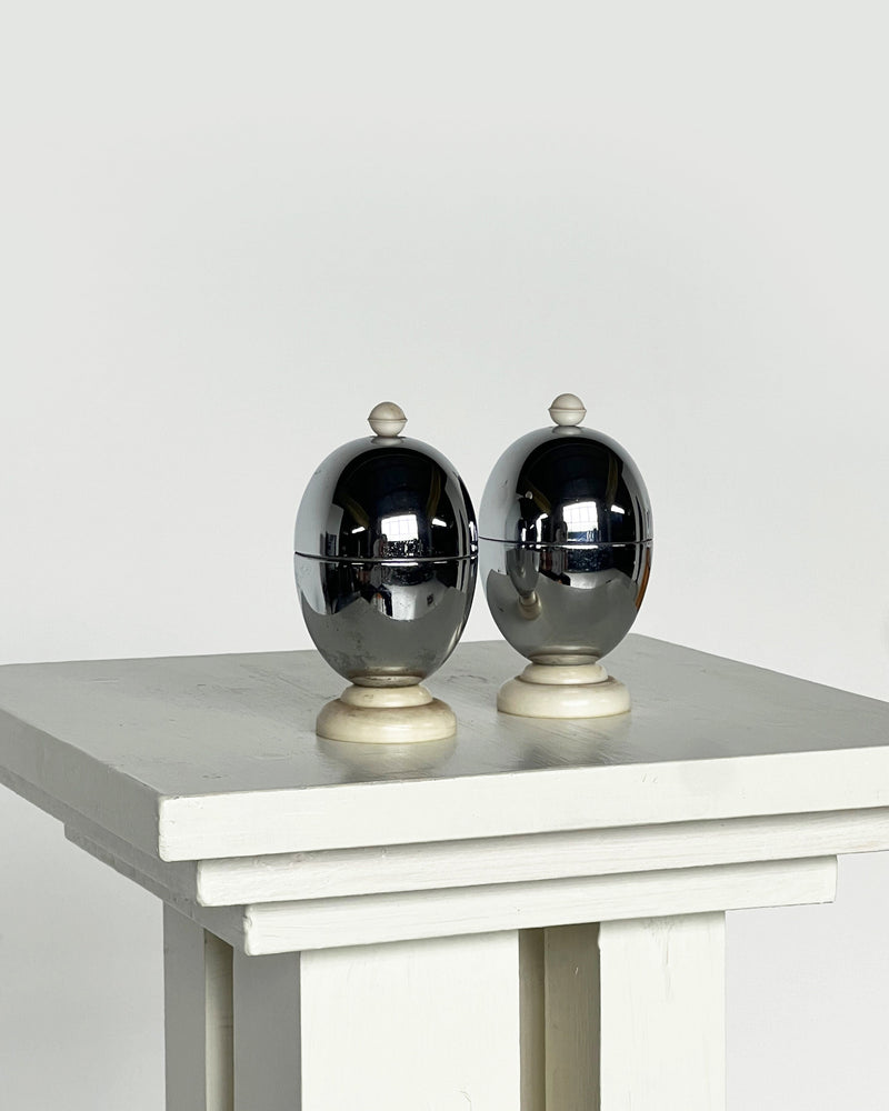 Pair of chrome deco egg warmers with cream ceramic bases