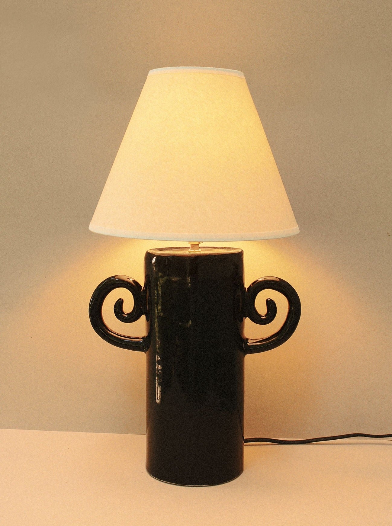 ###
A close-up image of the Espiral Lamp - Grande black showing its intricate spiral design and sleek black finish