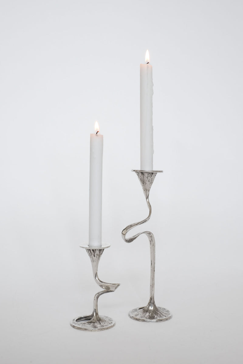 Vintage silver-plated twisted candle holders with lit white candles