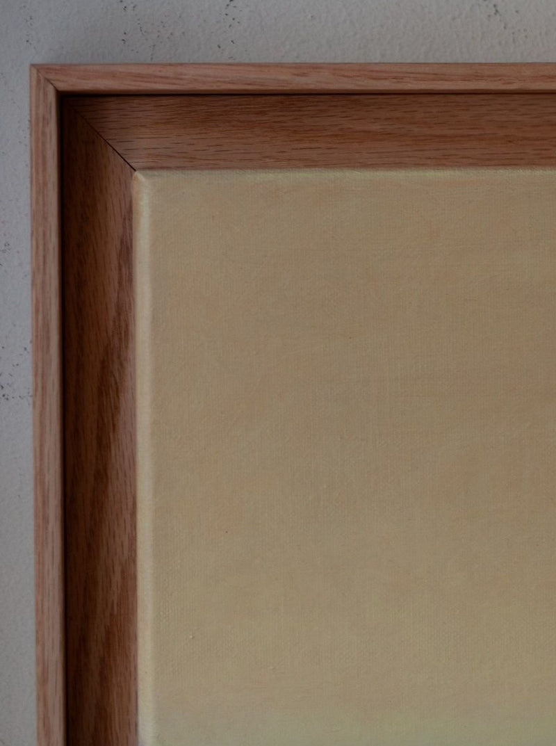 Close-up of the corner of a Rebecca von Matérn Untitled, 2024 hard wax oiled oak shadow frame with a stretched canvas, showing detailed textures of the wood and canvas against a plain background.