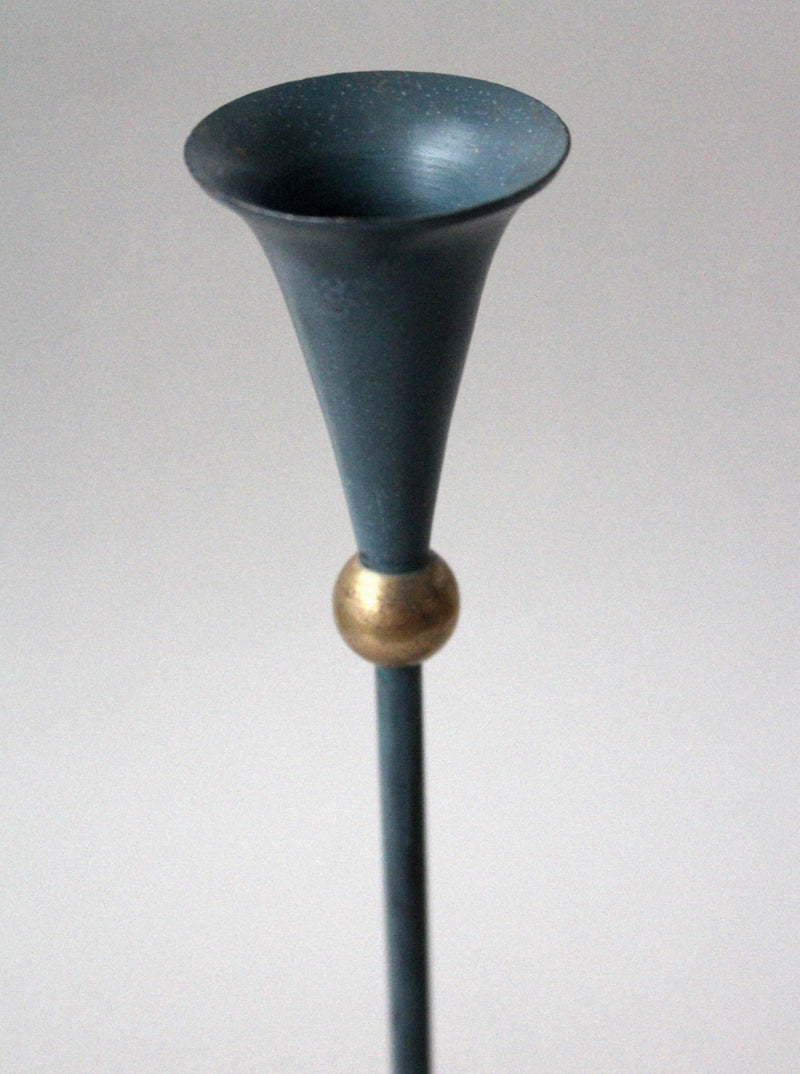 Detail view of Memphis design candleholder with teal funnel top and gold accent
