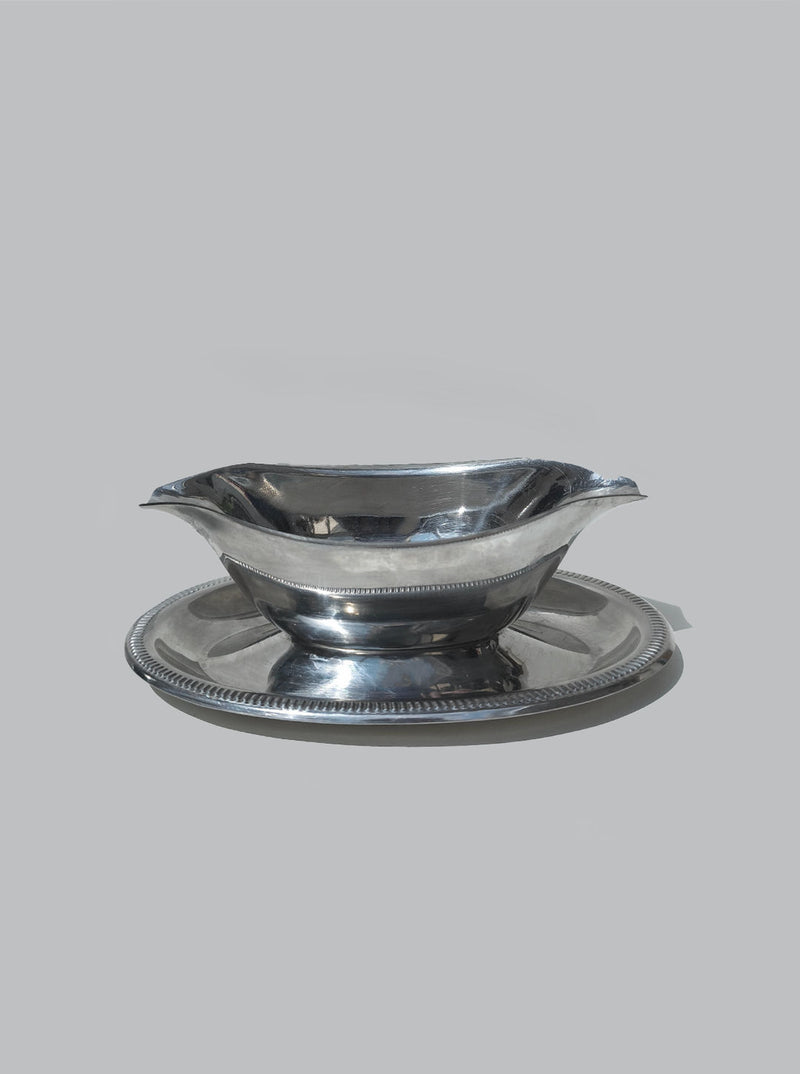 Polished steel gravy boat with matching saucer and rope edge detail