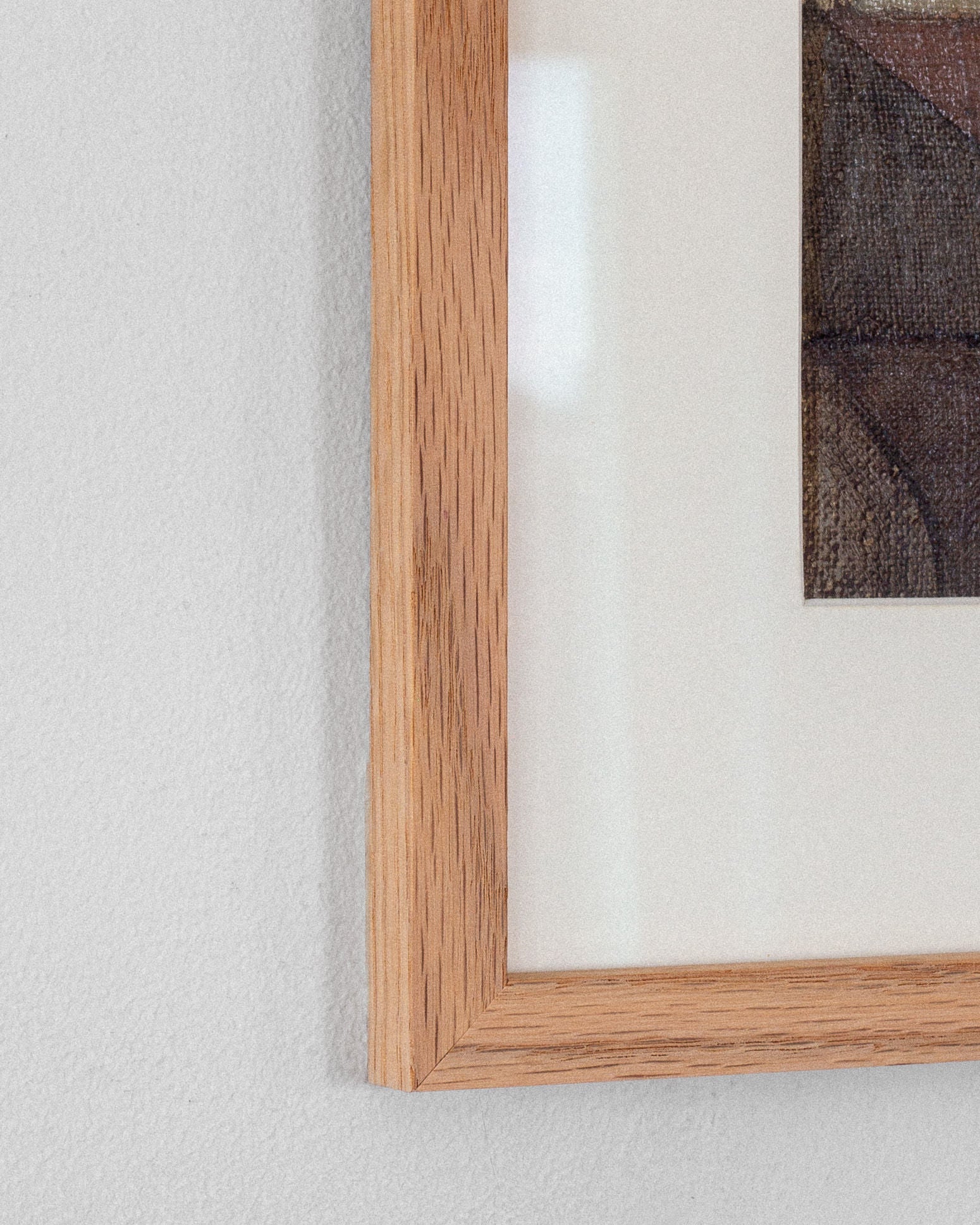 Close-up of a Spigel wooden picture frame on a textured white wall, highlighting the corner of the "Abstract Oil Painting by Carl Riise, Sweden 1970s," featuring muted colors and a cubist-inspired style.