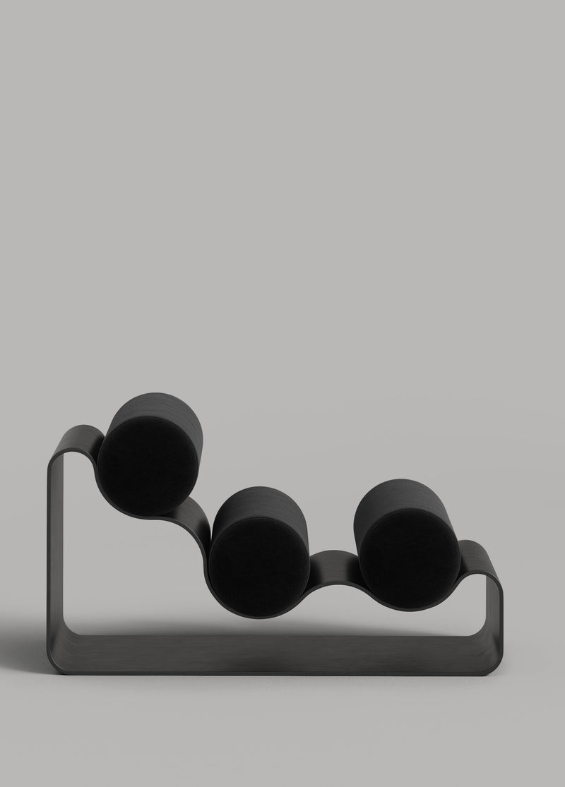 Modern aluminum chair with four spherical black seats on curved metal frame