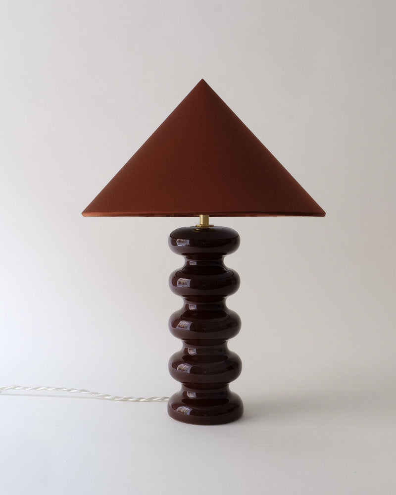 Sculptural ceramic table lamp with triangular shade, front view