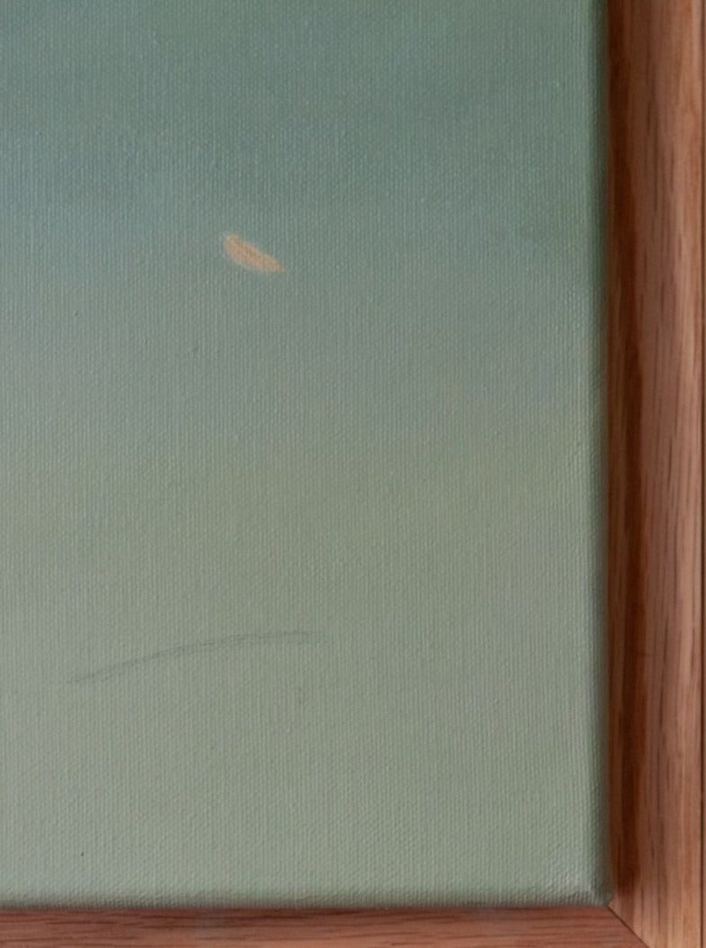 A close-up of a corner of a framed painting. The artwork, titled "Untitled," painting, 2024 by Rebecca von Matérn, consists of a smooth gradient of light green to blue hues, with a small yellowish spot near the center. The hand-waxed oak frame, seen on the right side and bottom of the image, has a natural finish that enhances its artistic prowess.