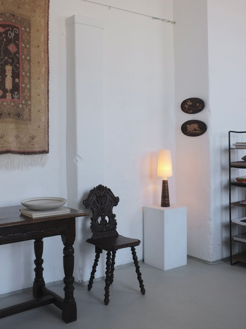 Stoneware table lamp styled in minimalist interior setting