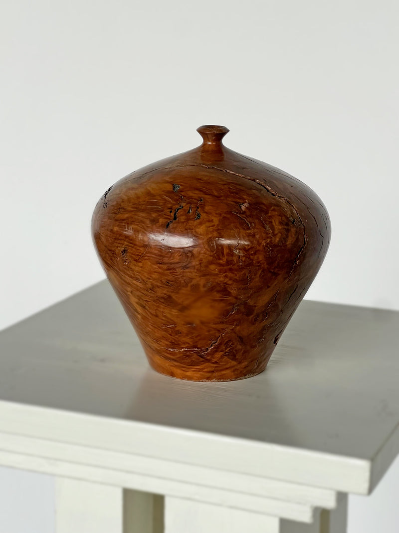 Amber burl wood vessel detail showing rich grain patterns