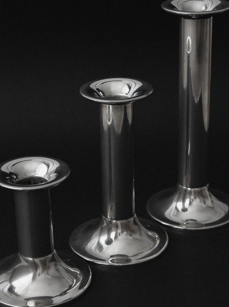 Three vintage silver plated candle holders in graduated heights