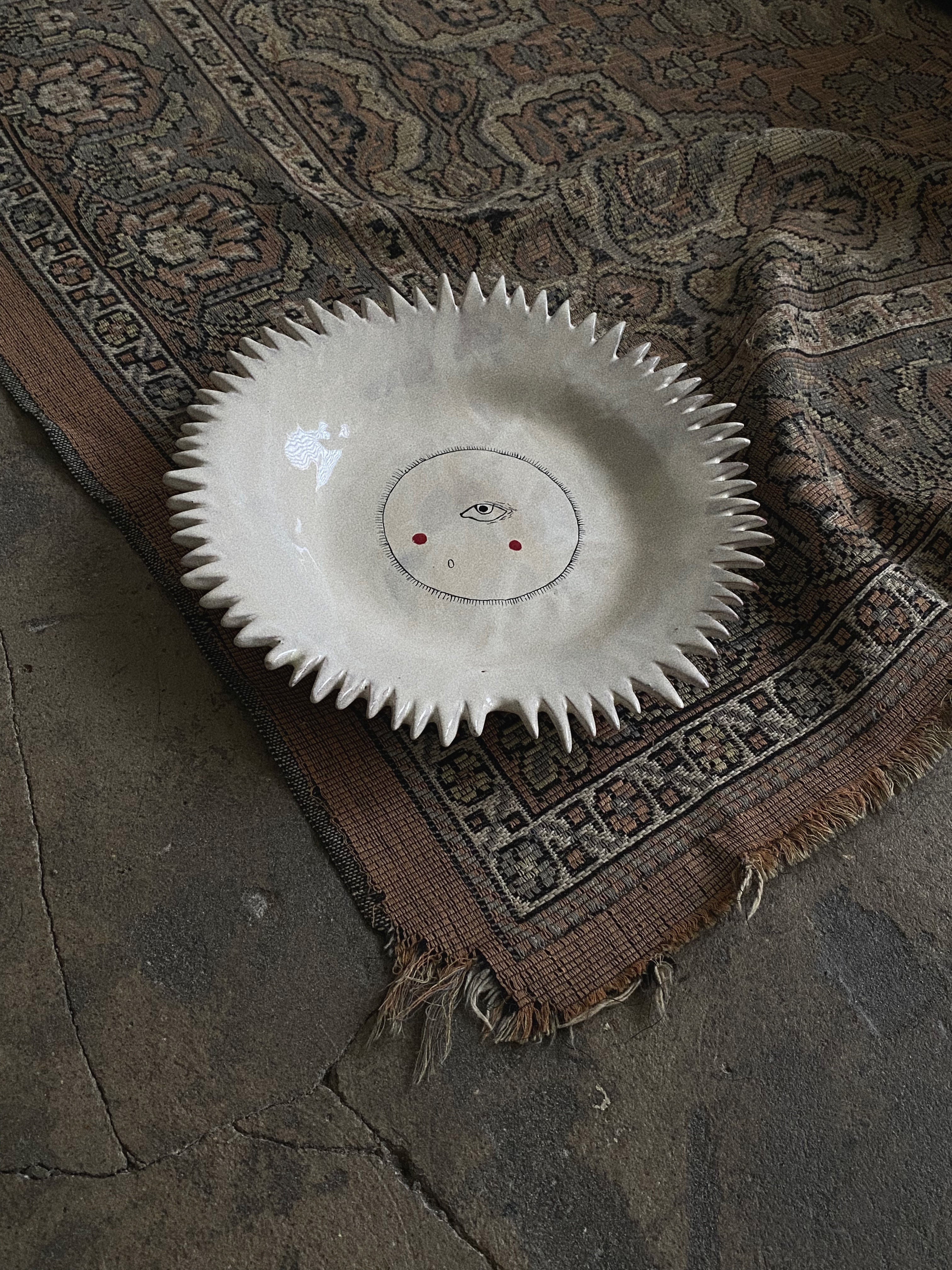 Handmade ceramic sun plate with intricate floral and sunburst design