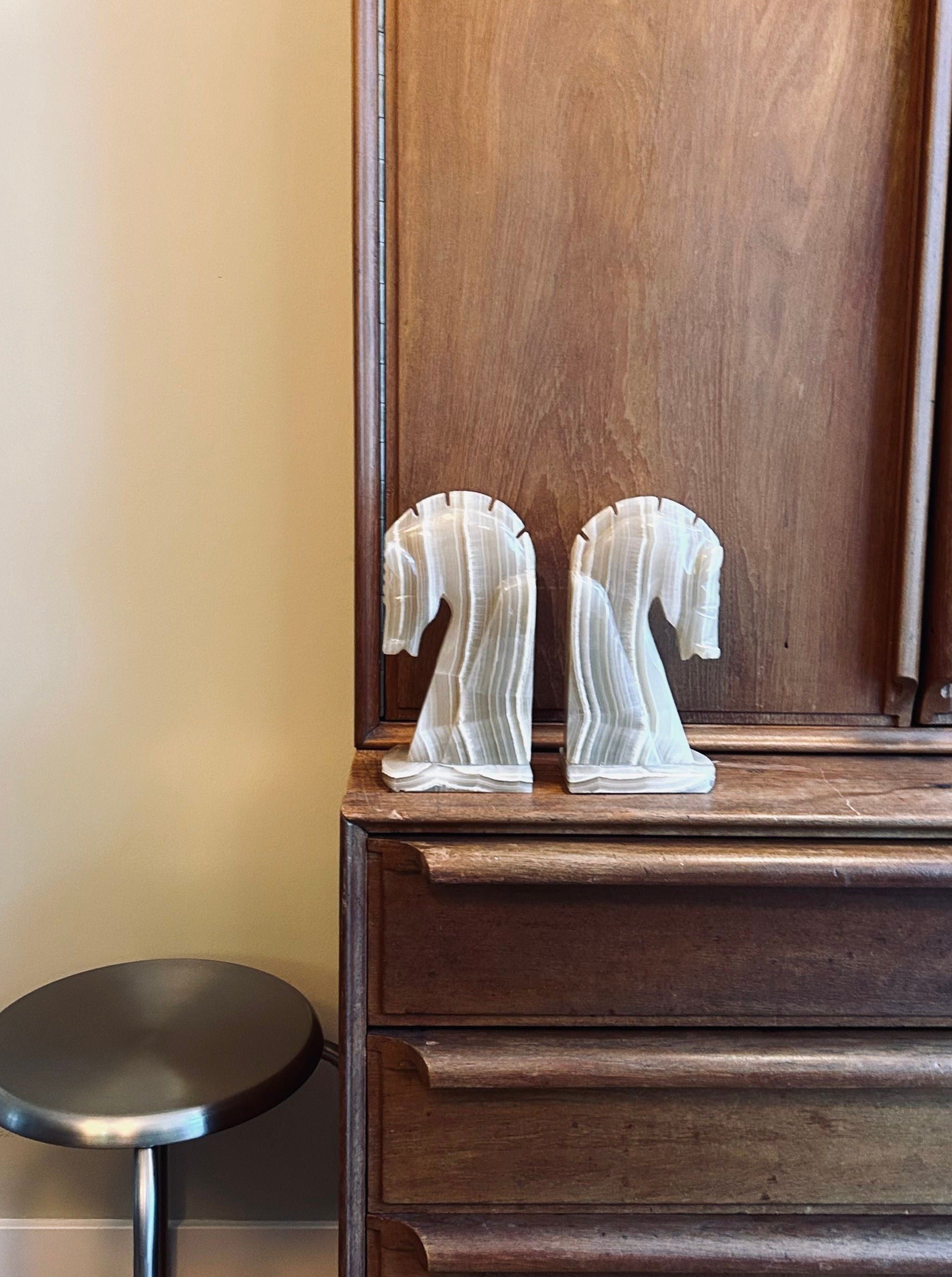 Pair of elegant onyx marble bookends featuring beautifully carved horse figures