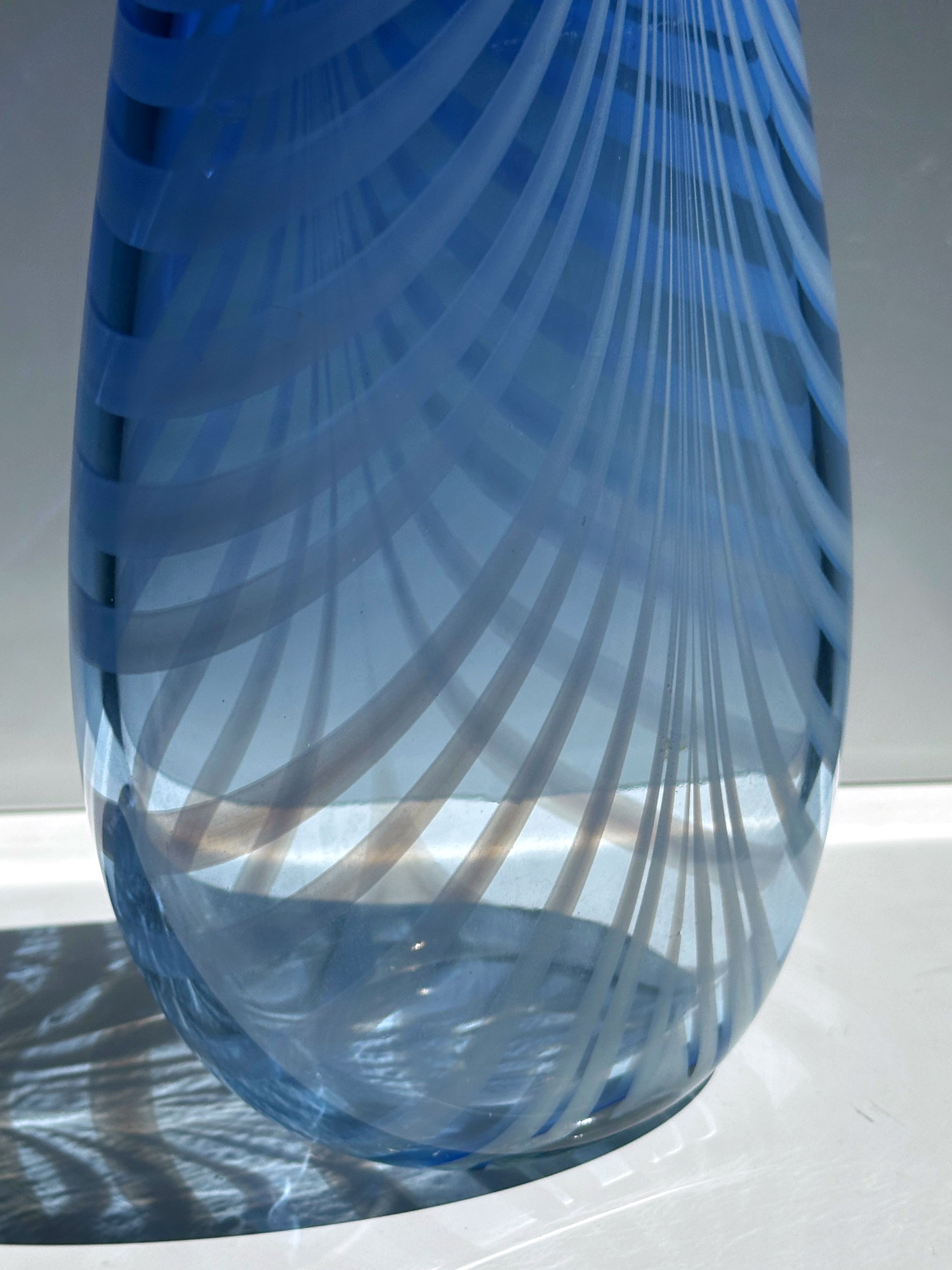 Blue art glass vase detail showing swirled optical pattern design