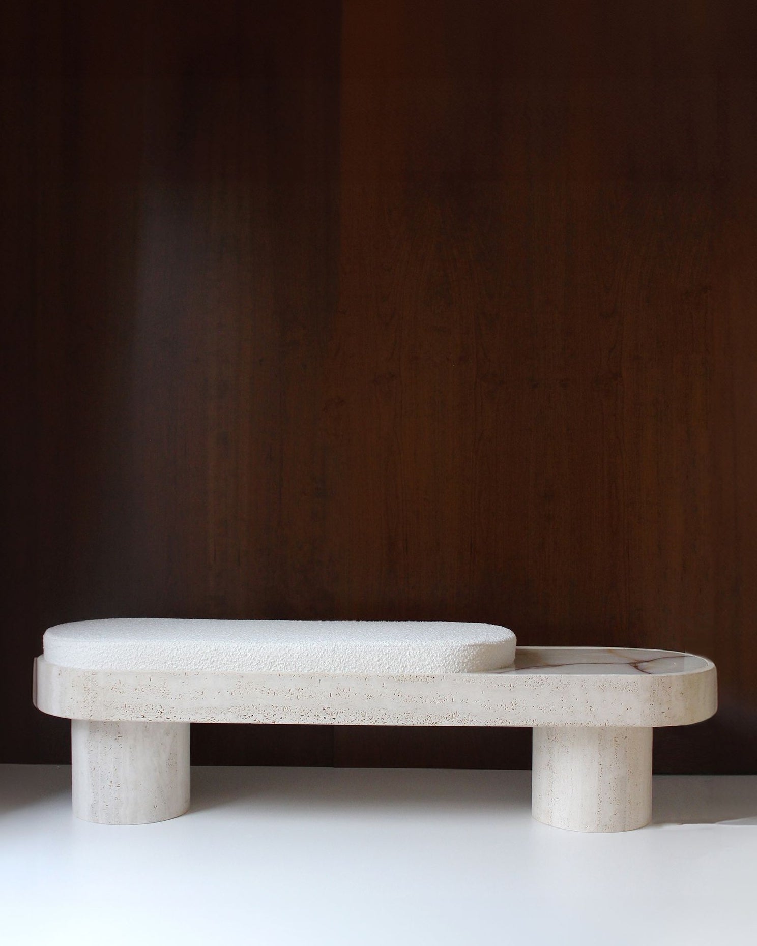 Noto travertine bench with curved seat and cylindrical legs