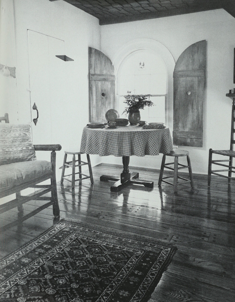 Colonial dining room interior with pedestal table and Windsor chairs