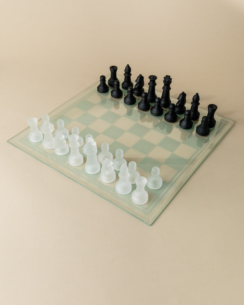 Transparent glass chessboard with frosted white and black pieces