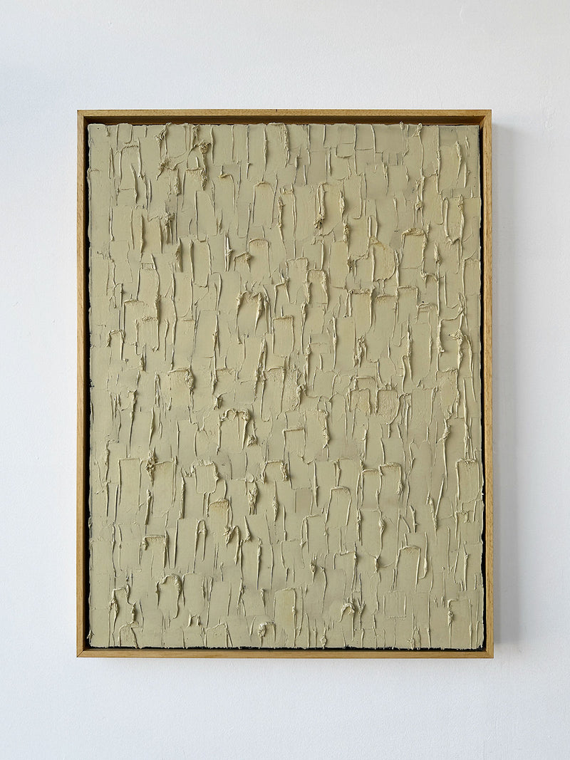 ‘Buff Titanium’ by Roi Elmaliah is a heavy texture oil on canvas in a wooden frame, featuring a grid of raised beige patches on a smooth light background, inspired by Amsterdam art, displayed against a white wall.