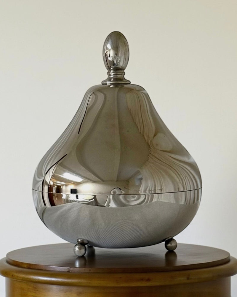 Polished silver pear-shaped serving vessel with domed lid on feet