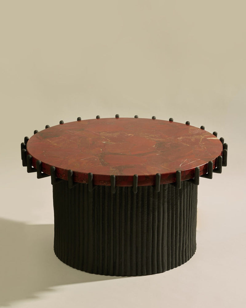 Sentinel round coffee table with red marble top and fluted black base