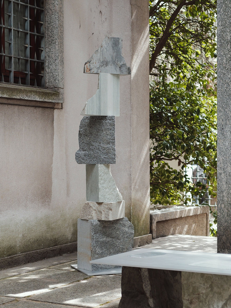 Contemporary stone sculpture with stacked geometric blocks in varied textures