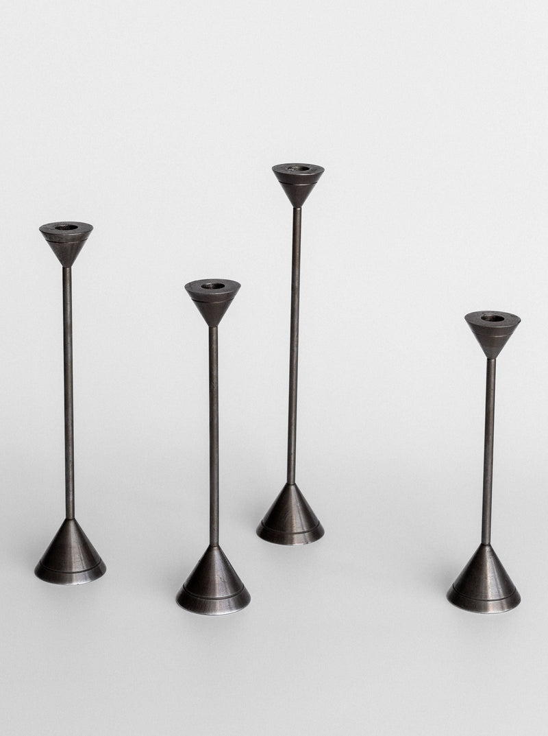 A group of stylish metal candle holders exuding a postmodern charm from Spigel's Set of Four Postmodern Candle Holders.