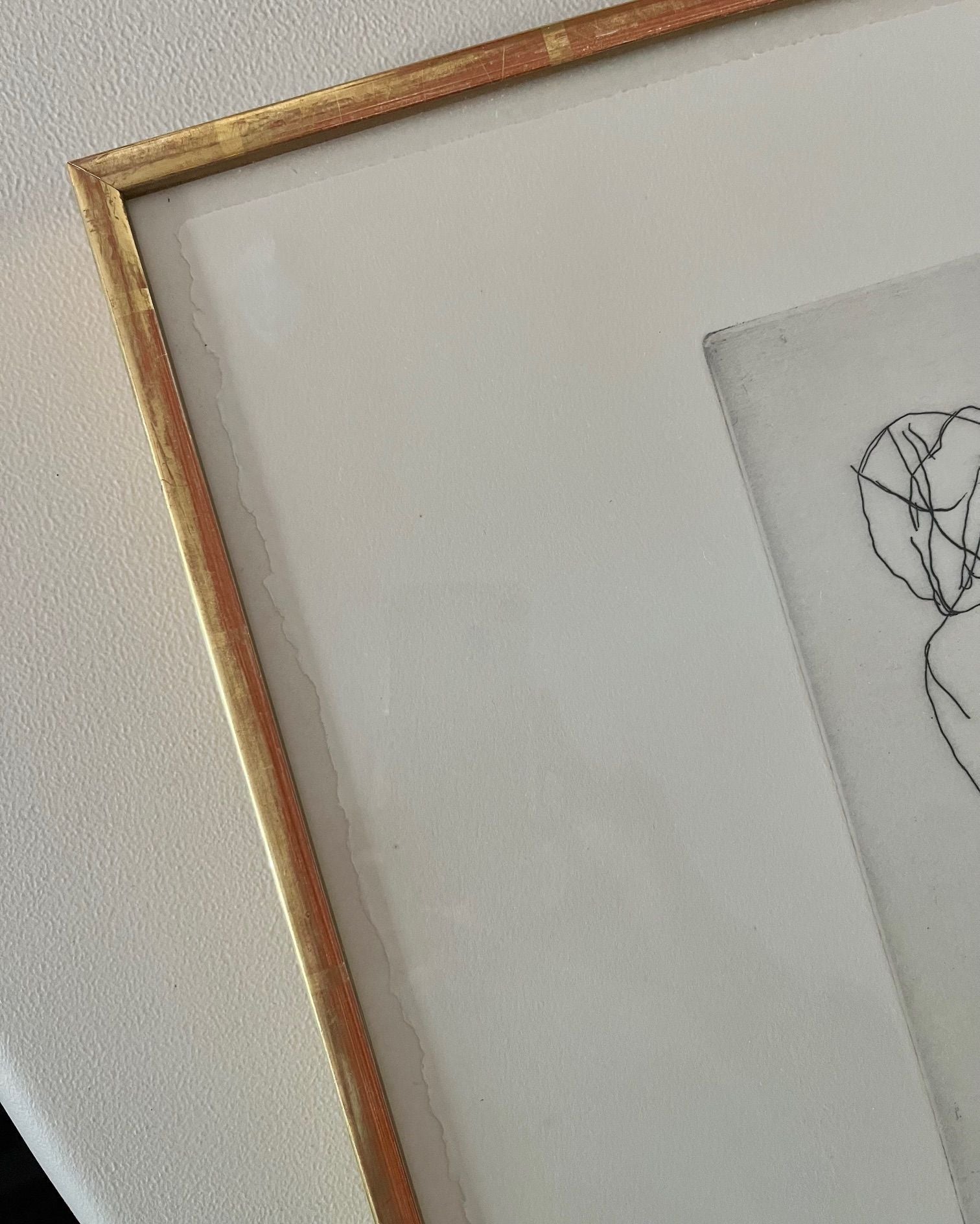 Corner detail of framed Fautrier nude drawing with golden frame