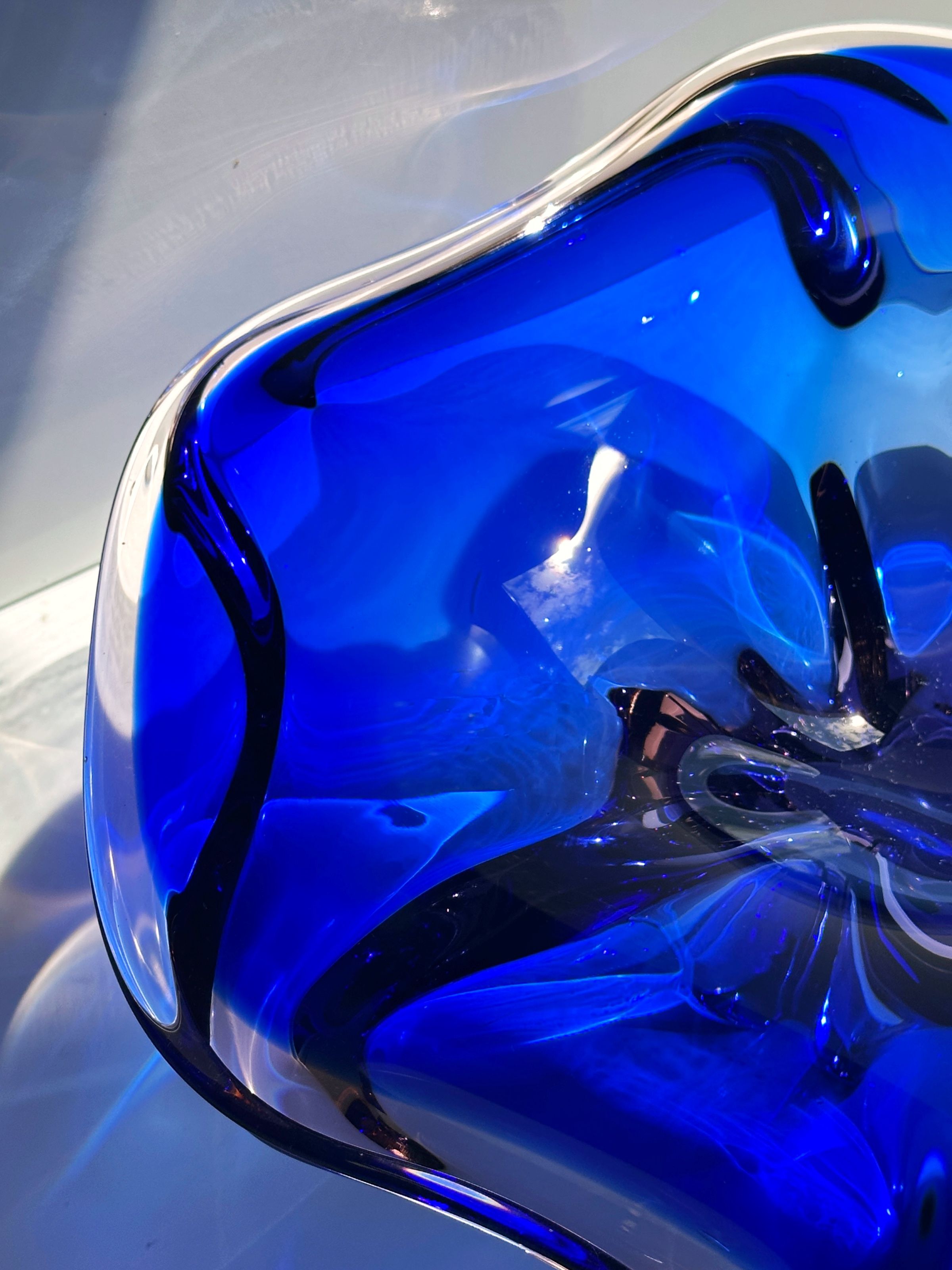 Deep blue Bohemian glass bowl showing curved interior details