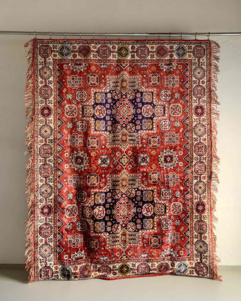 The Veter Vintage "Vintage Silk Oriental Duvet Cover - Rug" features bold geometric and floral patterns in red, white, purple, and black, with slightly uneven fringed edges that add charm to this eye-catching decorative piece.