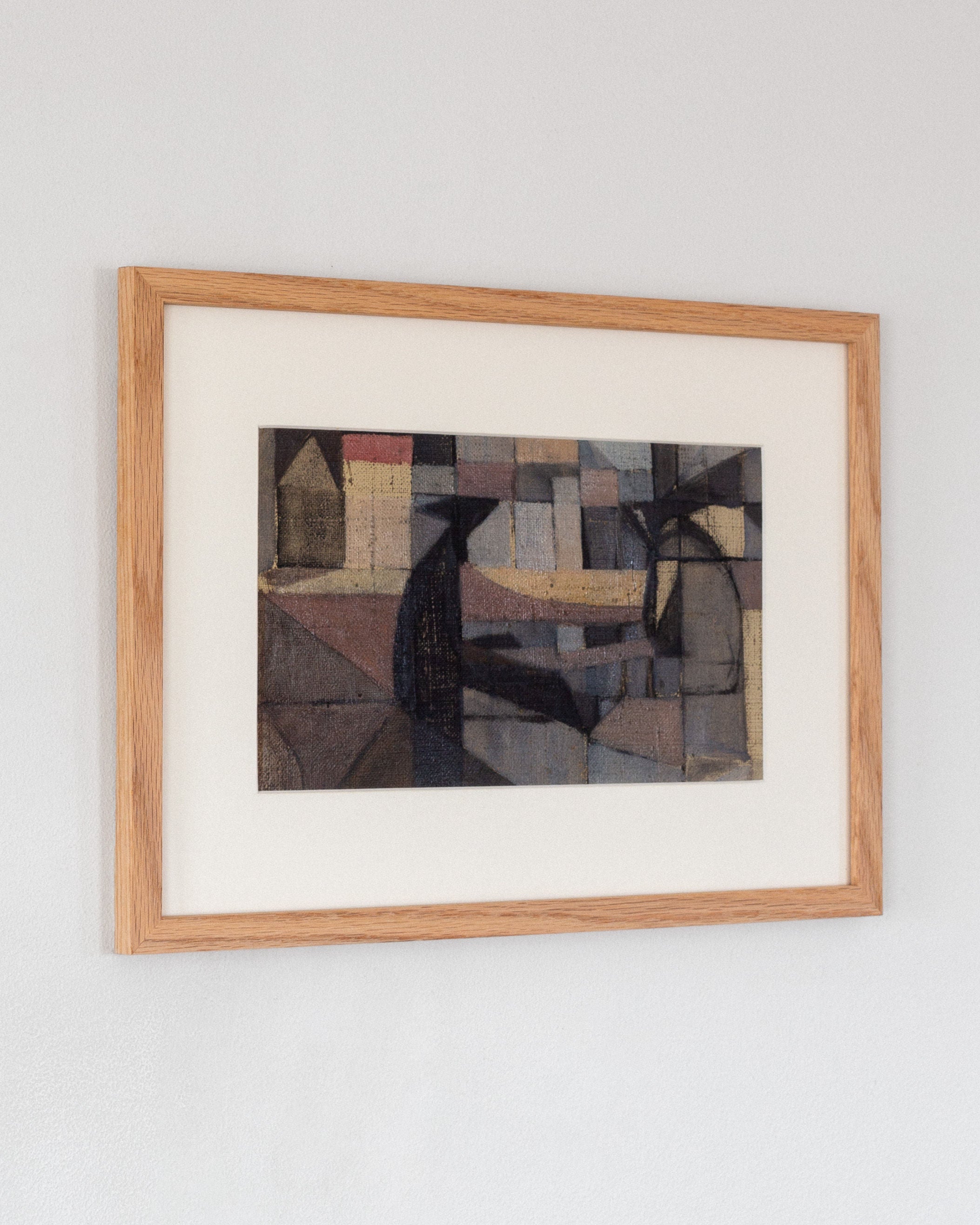 An Abstract Oil Painting by Carl Riise from the 1970s, offered by Spigel, is mounted on a light gray wall. The cubist-influenced piece showcases geometric shapes in muted hues—brown, black, gray—and touches of yellow and pink create a textured mosaic effect. The painting is framed in wood.