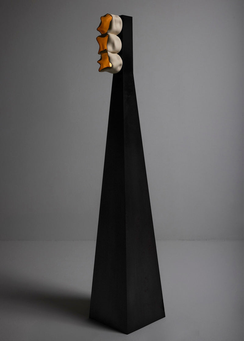 Modern black pyramidal floor lamp with three illuminated vessels at top