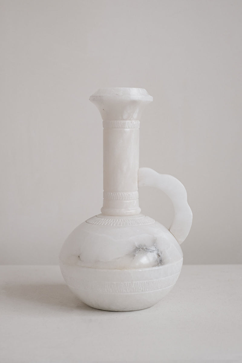 White alabaster vase with elongated neck and curved handle detail
