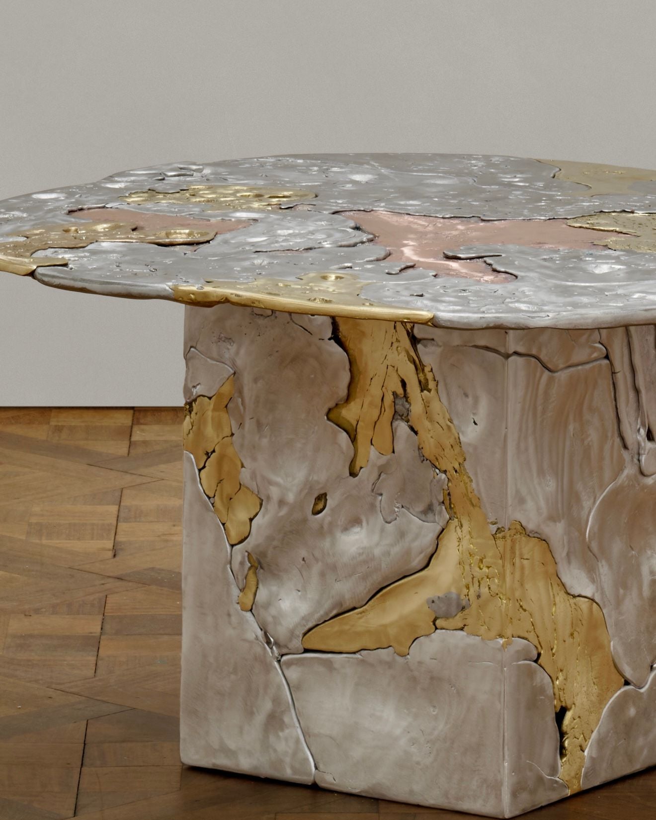 The Sheyang Li 'Elemental Patchwork' Coffee Table features an abstract metallic surface and base in silver, gold, and bronze tones, with textured cast metals showcasing visible seams and cracks for an organic, artistic look.