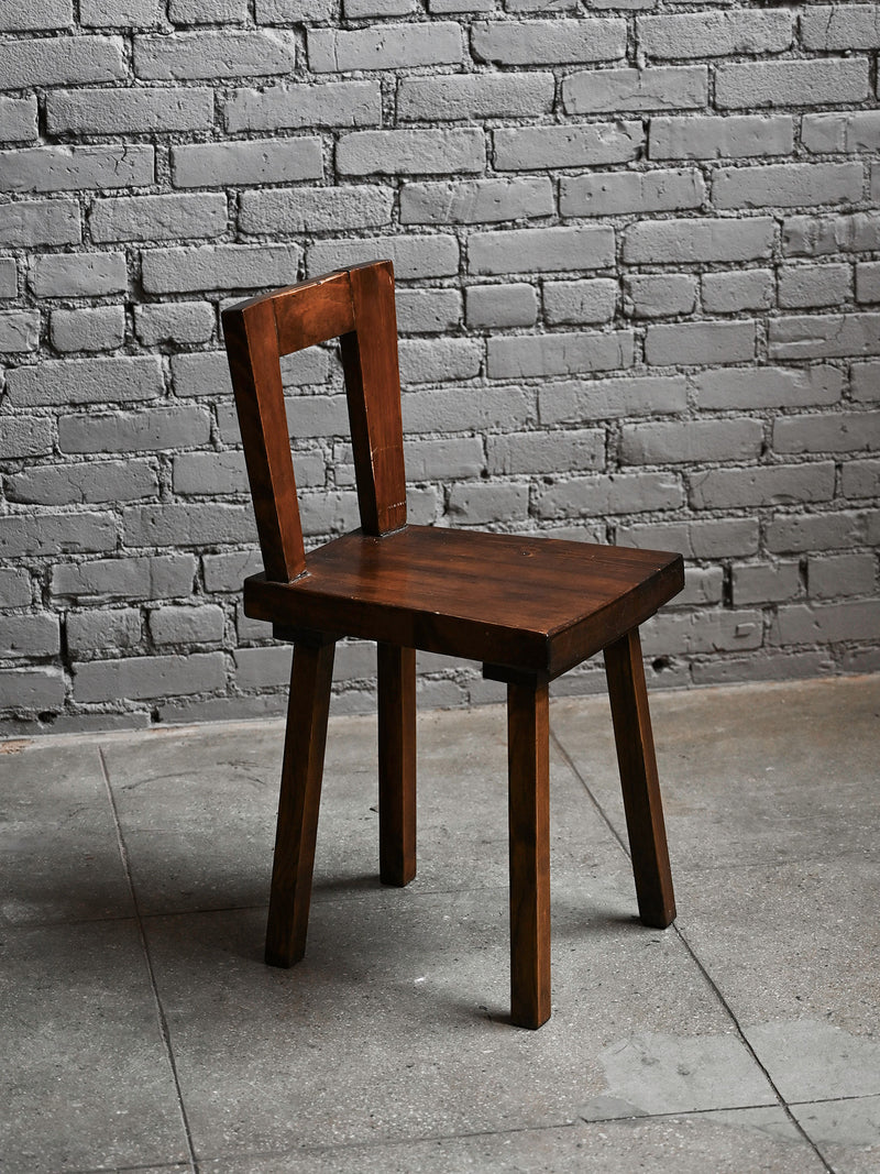 1940s geometric wooden chair with square backrest on concrete floor