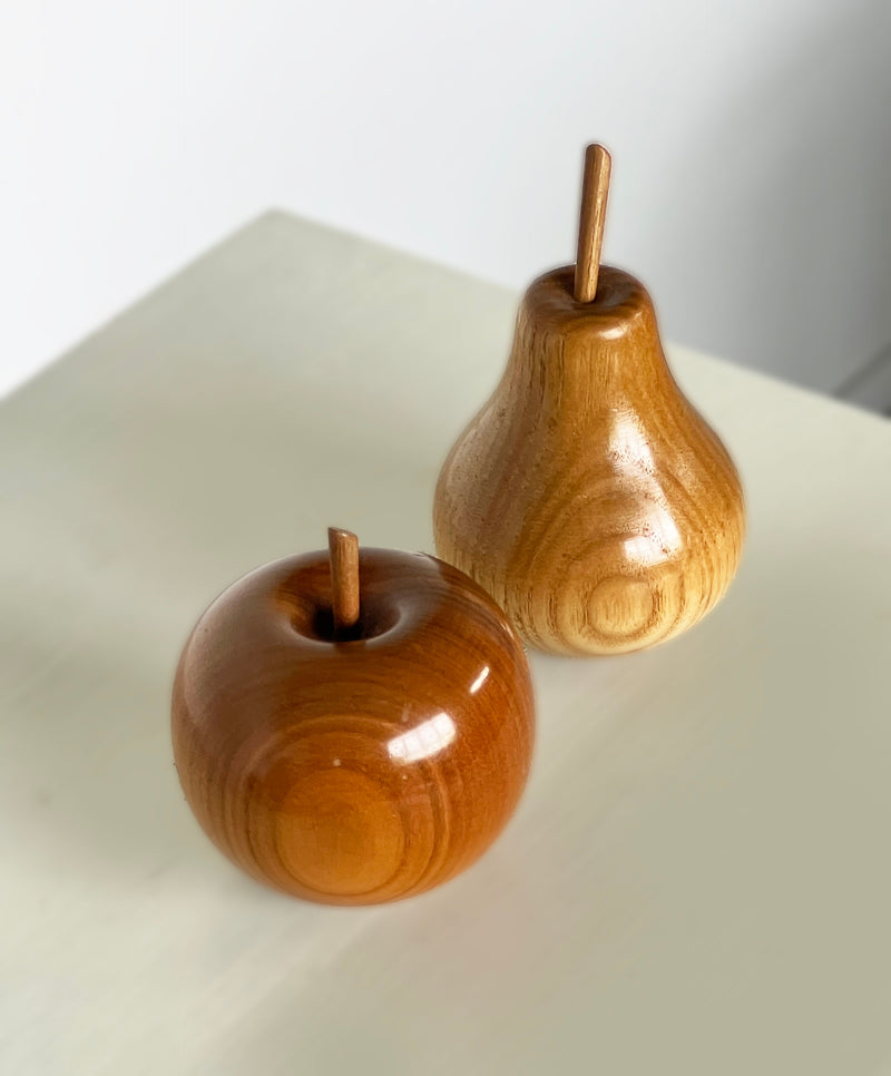 Polished wood apple and pear sculptures with natural grain detail