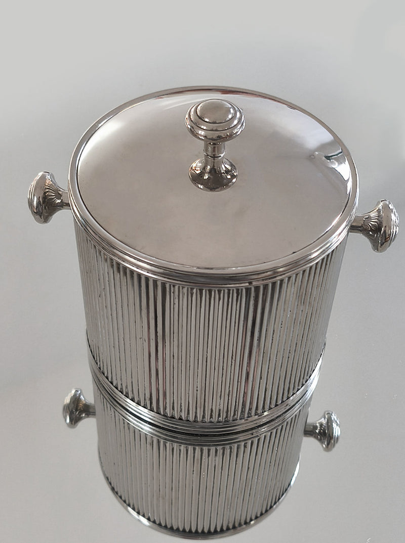 Silver plated ice bucket with ribbed texture and ornate handles