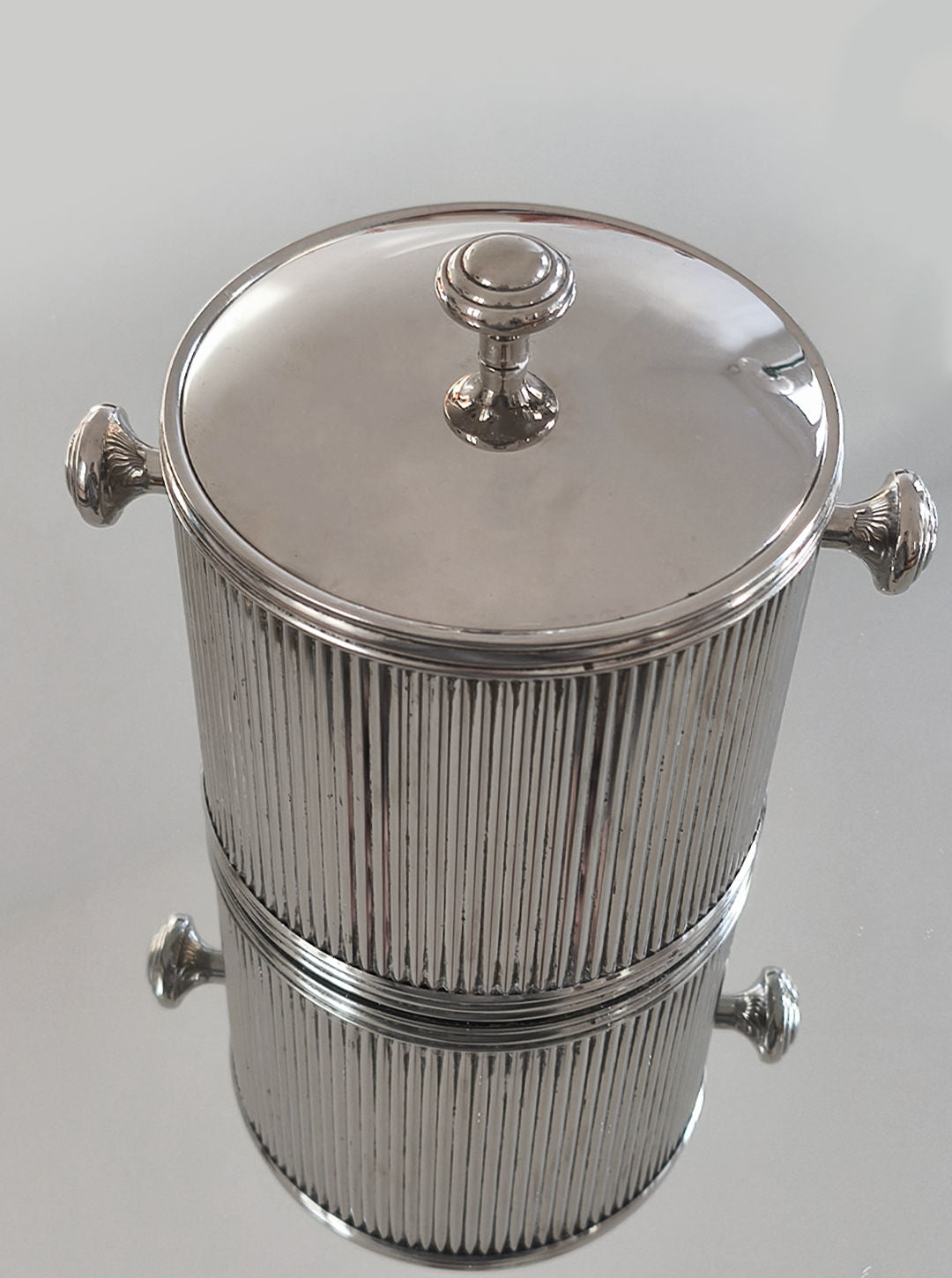 Silver plated ice bucket with ribbed texture and ornate handles