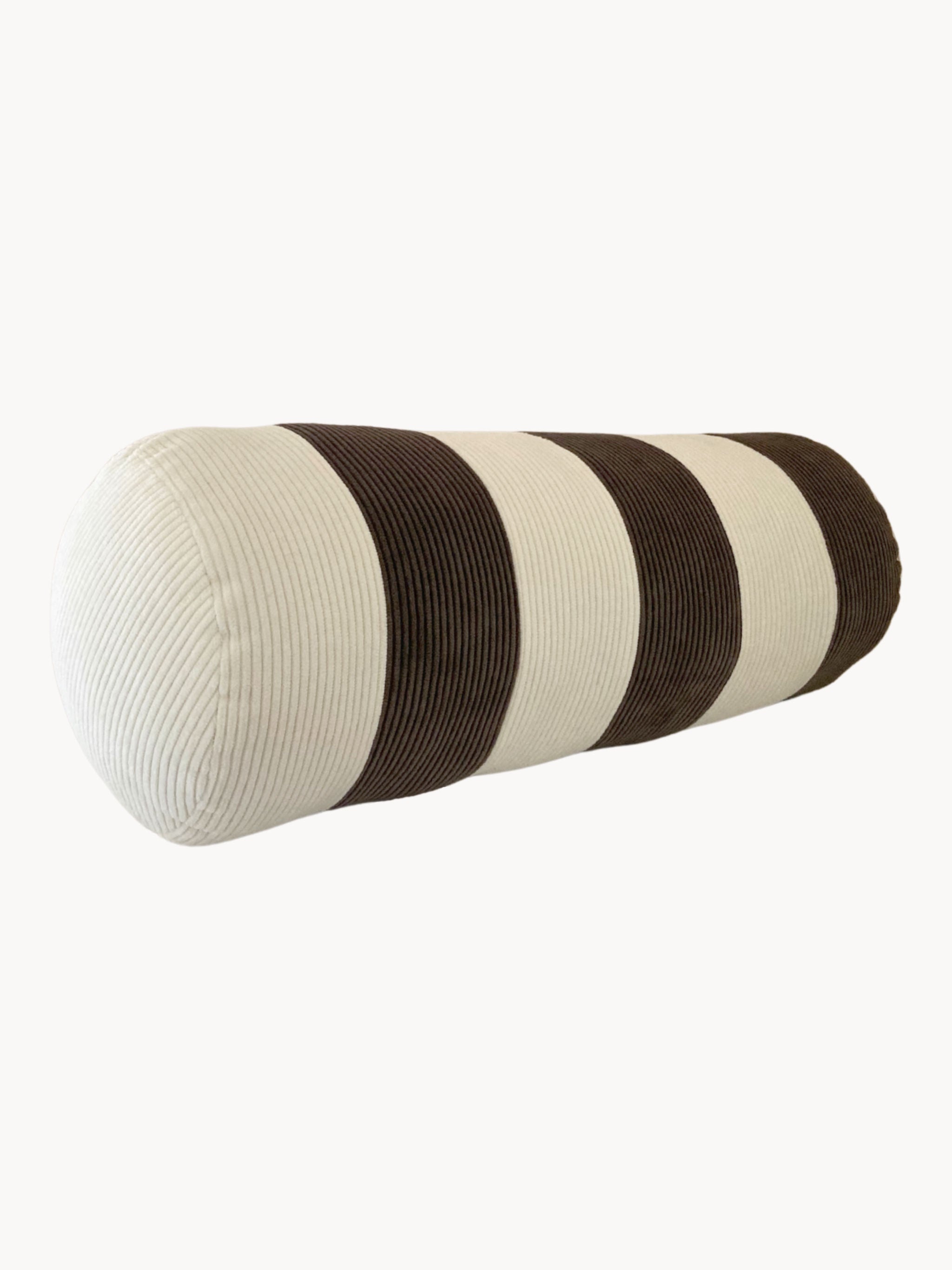 A cylindrical bolster pillow with alternating horizontal stripes in white and dark brown corduroy fabric, reminiscent of a vintage-inspired patchwork cushion. Handmade in the UK, its texture appears soft and plush against a plain white background. The Le Cylindre - Cotton Corduroy - Espresso/Chalk by AMÉLIORÉ.