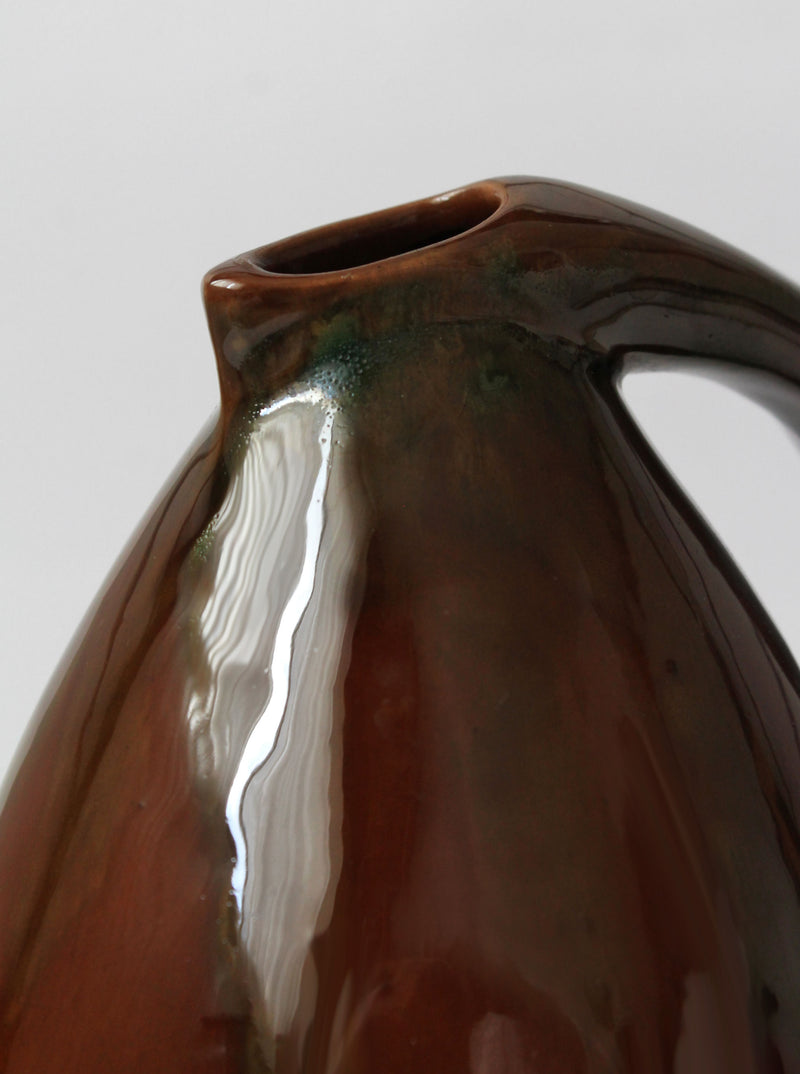 Close-up detail of vintage ceramic jug glazed in brown tones
