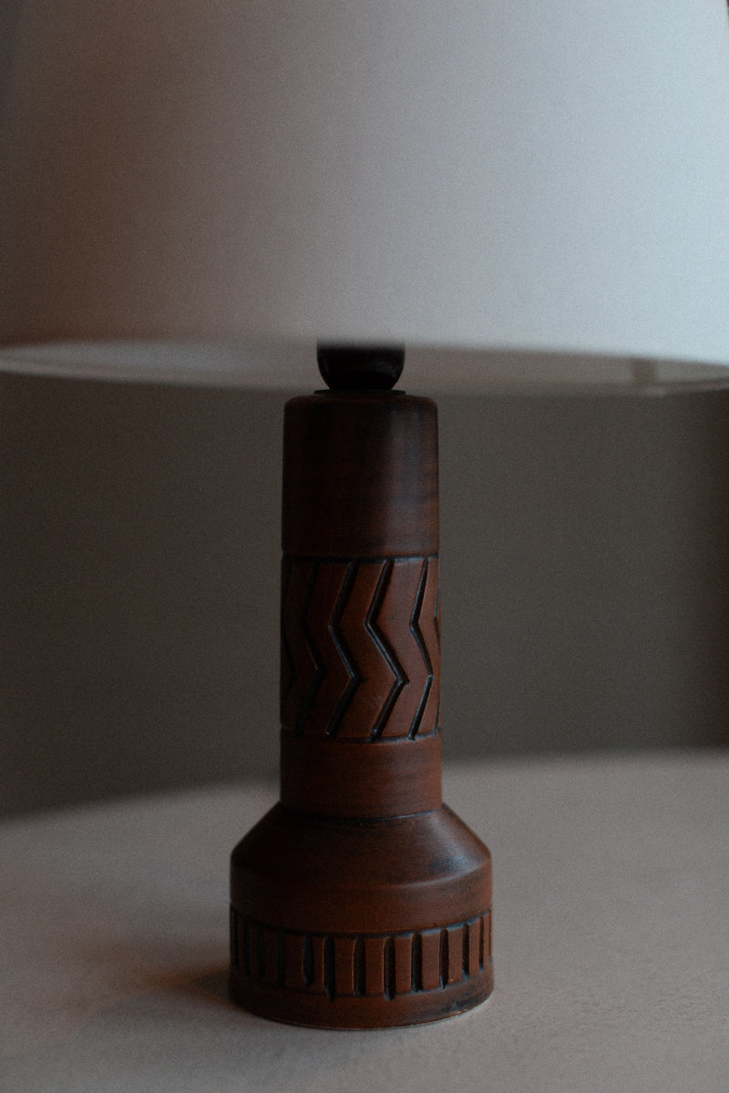 Vintage stoneware lamp with earthy tones and textured finish 