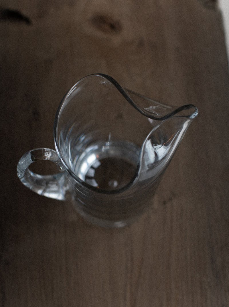 Elegant glass pitcher with spout and comfortable handle for easy pouring
