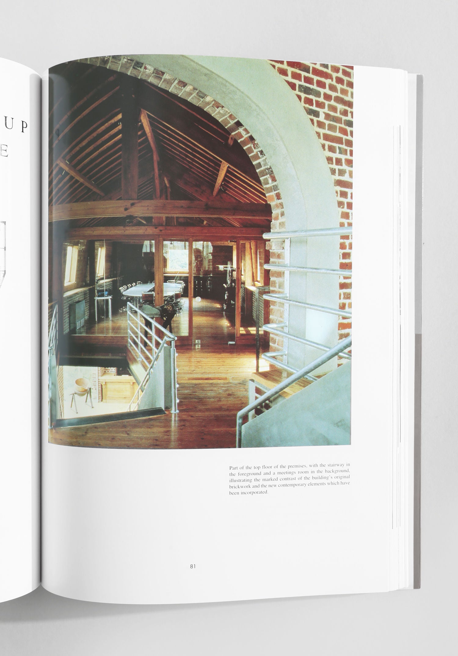 The 'Commercial Space: Offices, Design and Layout' book by Villa showcases inspiring loft interiors with wooden beams, brick walls, arched doorways, metal railings, and large windows—highlighting striking architecture and vintage style.