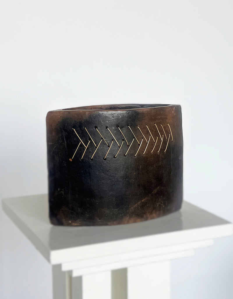 Terracotta vase with gold stitching detail by Porter Studio